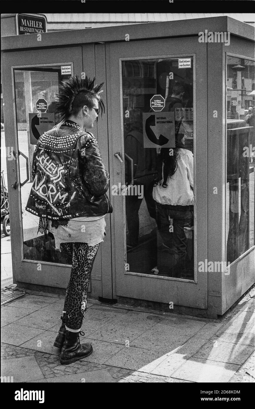 Punk girl waiting in front of a telephone box (West Berlin) Stock Photo
