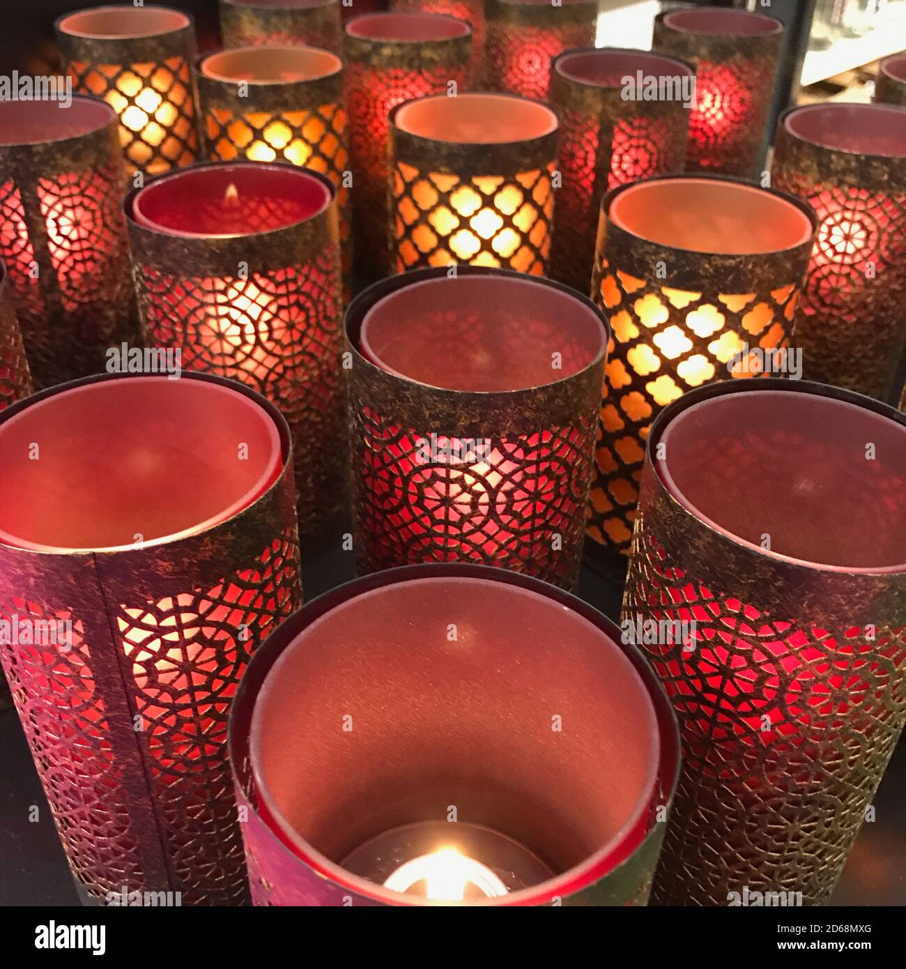 a Large group of red eastern candle holders with burning candles on a table  Stock Photo - Alamy
