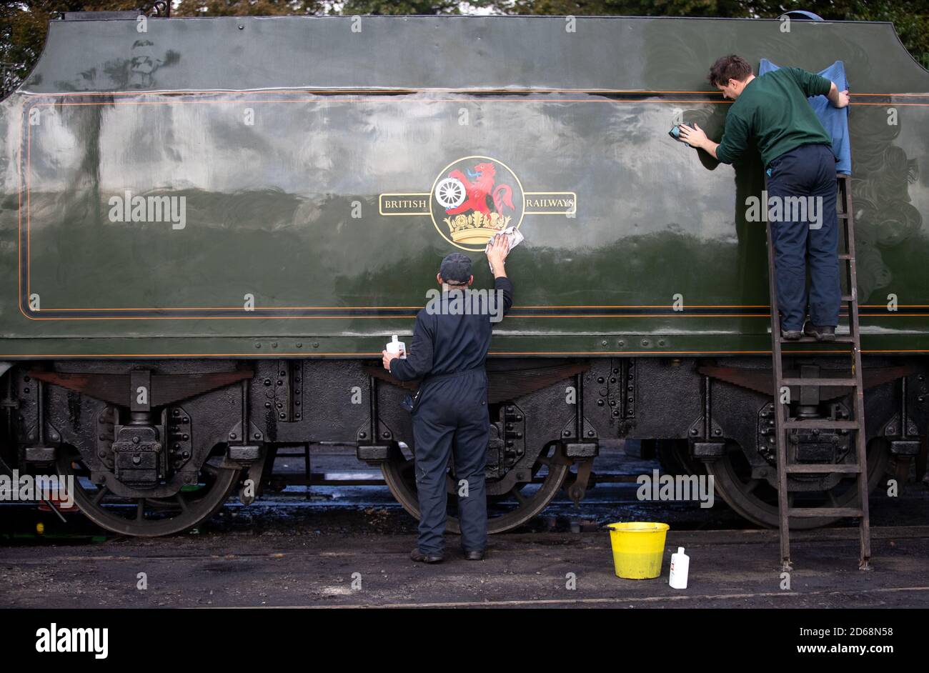 Volunteers clean the tender for the SR V Schools class steam locomotive 'Cheltenham' at Ropley station ahead of this weekend's Autumn Steam Gala on the Mid Hants Railway's Watercress Line. Stock Photo