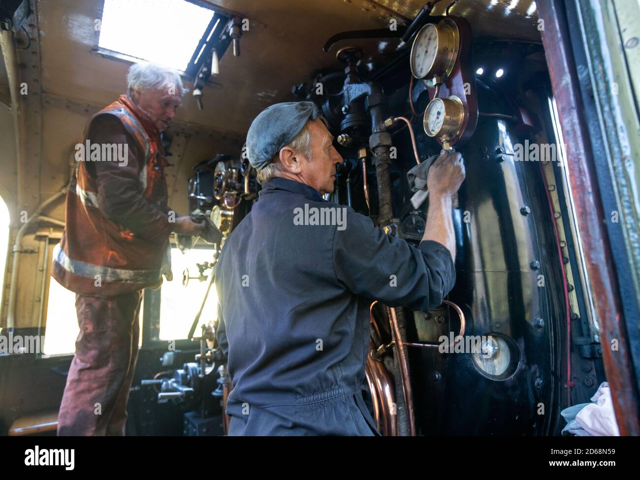 Gauges are cleaned inside the LMS Jubilee class 4-6-0 steam locomotive 45596, ???Bahamas??? is cleaned whilst at light steam at Ropley station ahead of this weekend's Autumn Steam Gala on the Mid Hants Railway's Watercress Line. Stock Photo