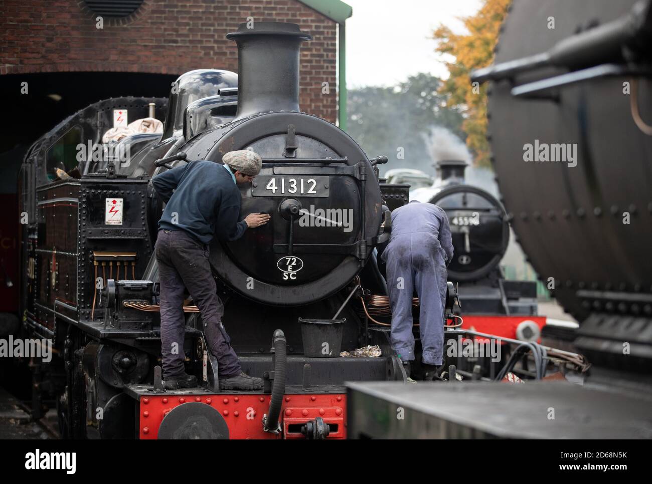 Volunteers clean the British Railways Ivatt Class 2MT Tank Engine number 41312 at Ropley station ahead of this weekend's Autumn Steam Gala on the Mid Hants Railway's Watercress Line. Stock Photo