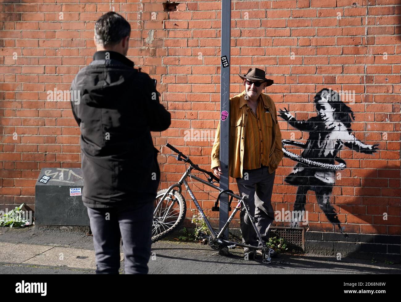 Nottingham residents take their photograph next to graffiti artwork