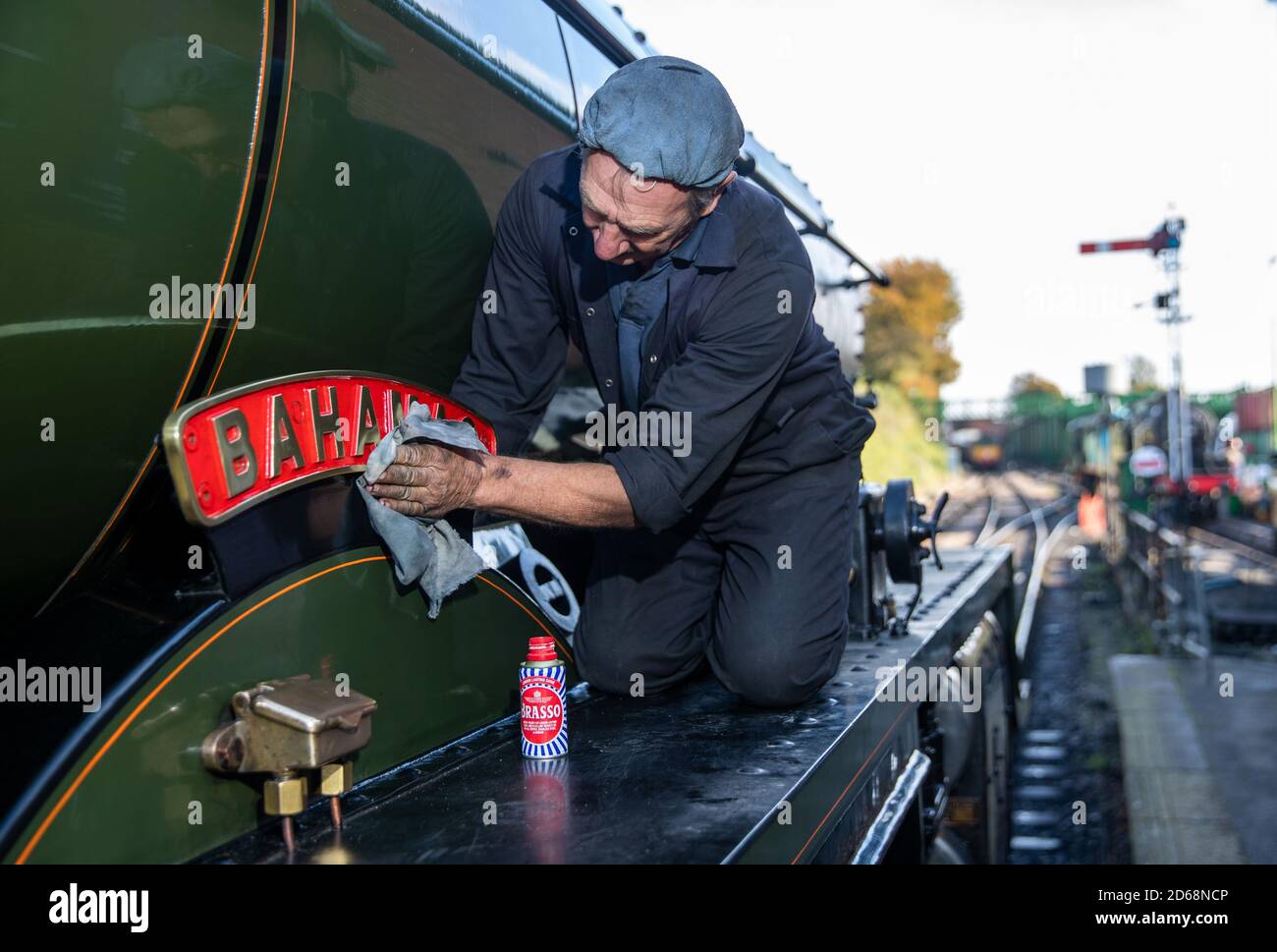 The name plate for the LMS Jubilee class 4-6-0 steam locomotive 45596, ???Bahamas??? is cleaned whilst at light steam at Ropley station ahead of this weekend's Autumn Steam Gala on the Mid Hants Railway's Watercress Line. Stock Photo