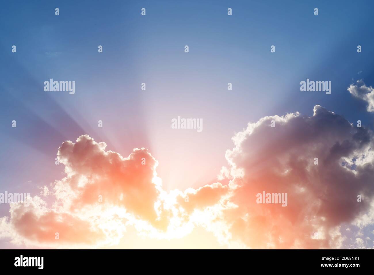 Sunset rays behind the clouds and shadows on blue sky, copy space Stock ...