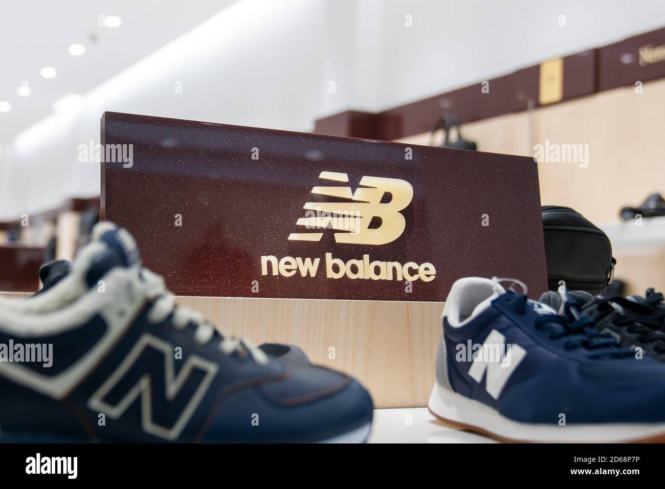 Krasnoyarsk, Russia, October 15, 2020: New Balance sneakers and the footwear company logo. showcase and counter in the store, shopping specialty store Stock Photo