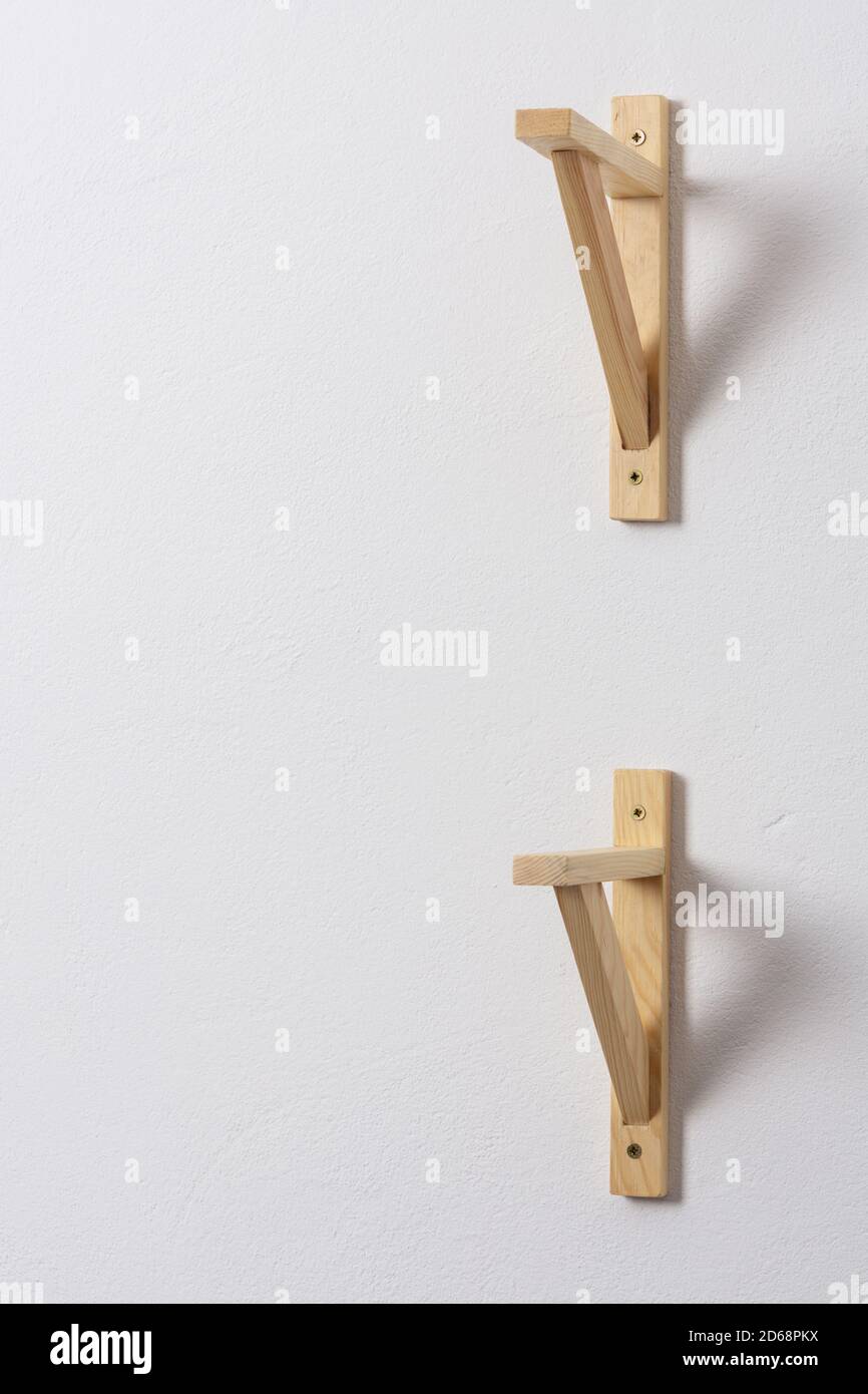 The process of attaching a wooden shelf to the wall, shelf corners