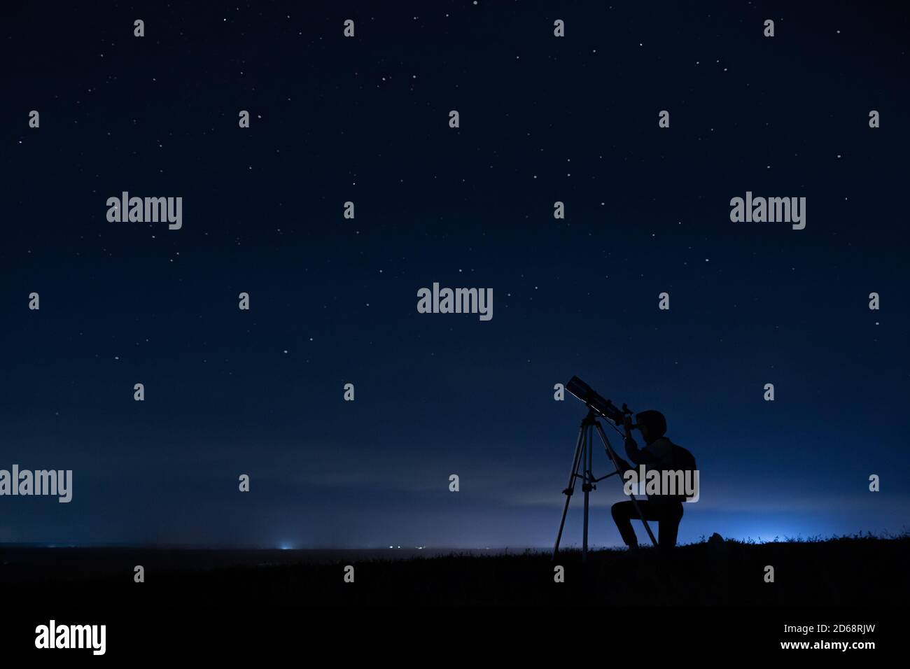 Human silhouette and telescope, a woman looks through a telescope at the  starry sky. Night sky, stars, long exposure, astronomy Stock Photo - Alamy