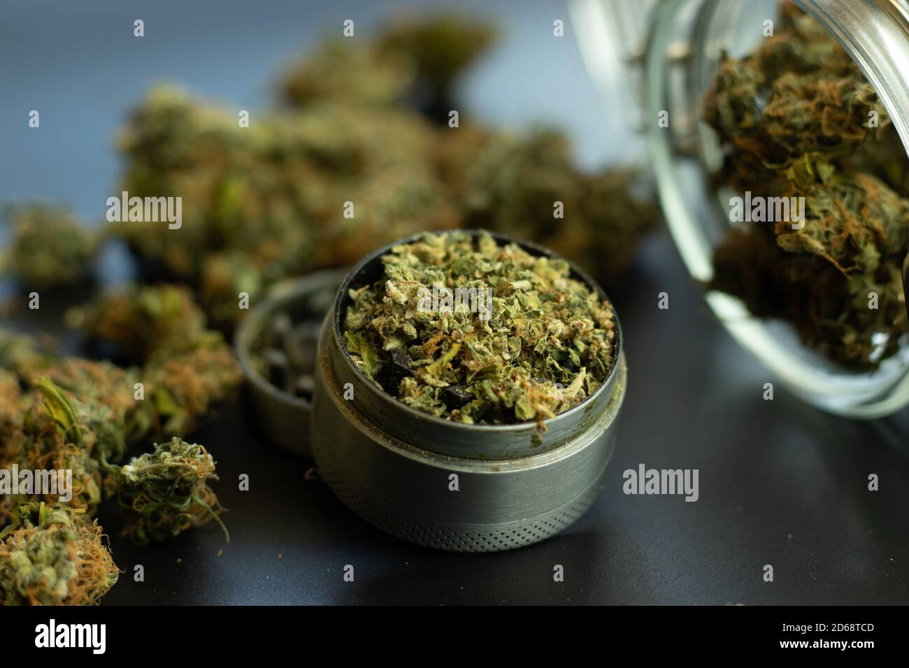 Legal use of cannabis for medical purposes. Marijuana bud background, weed in grinder and jar close up Stock Photo