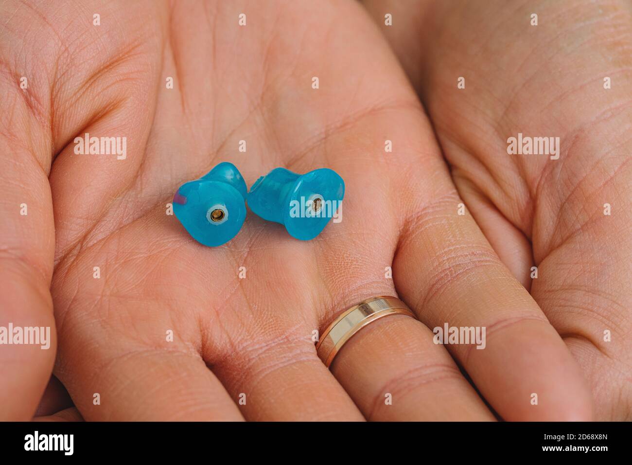 Earplugs for use in an airplane at high atmospheric pressure with pressure valve in hands, top