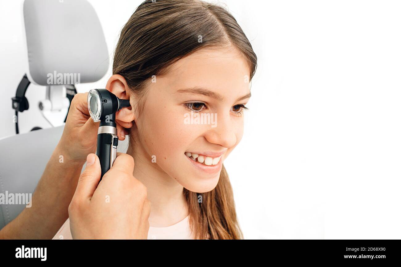 Child hearing exam. Diagnosis of impairment and hearing testing in children. Girl during an ear checkup with an audiologist Stock Photo