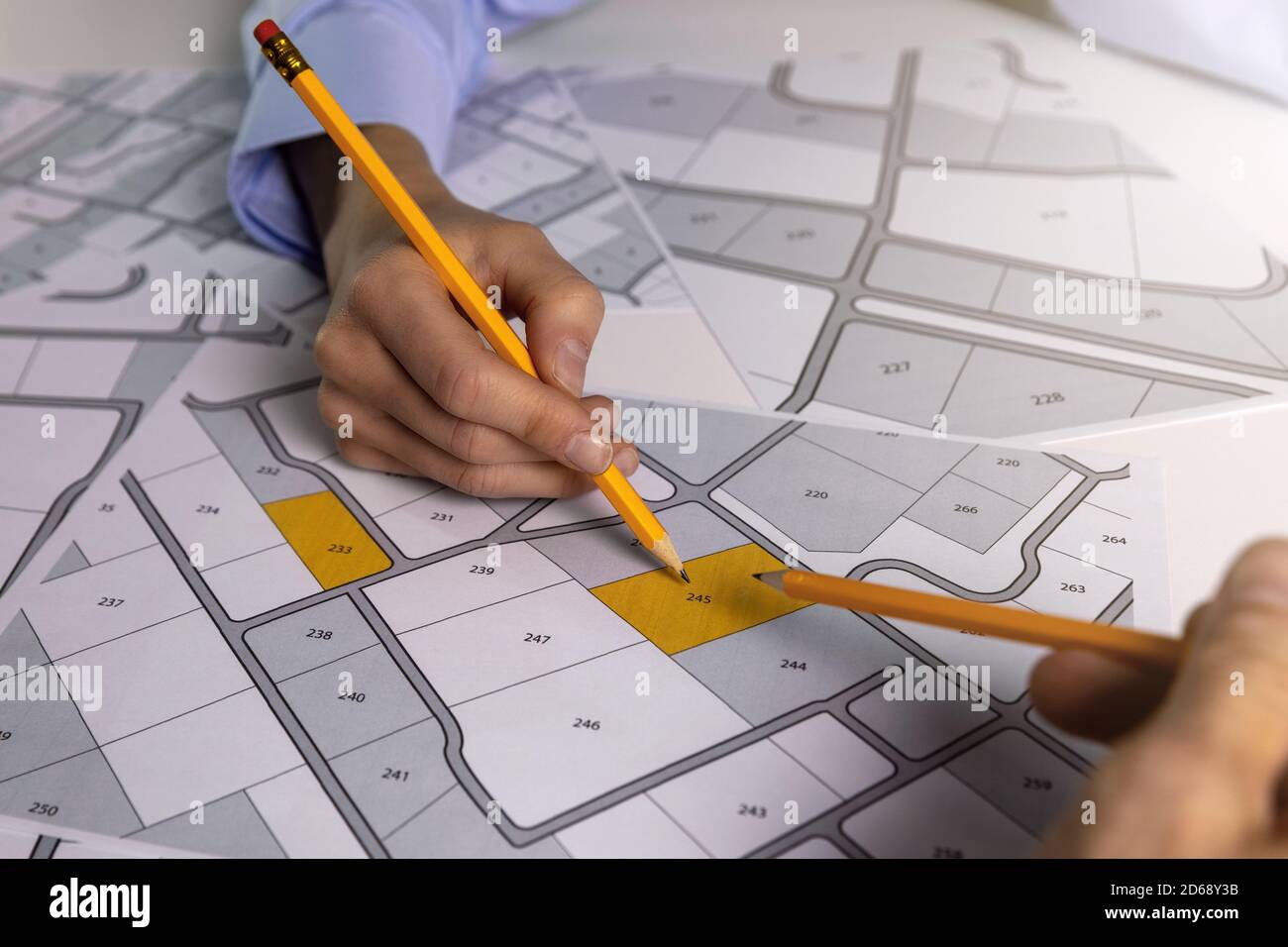 people discussing about territory building plots on cadastral map Stock Photo