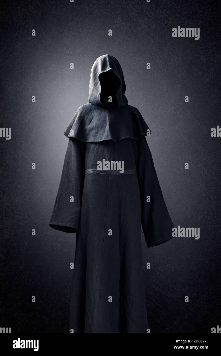 Scary figure in hooded cloak Stock Photo - Alamy