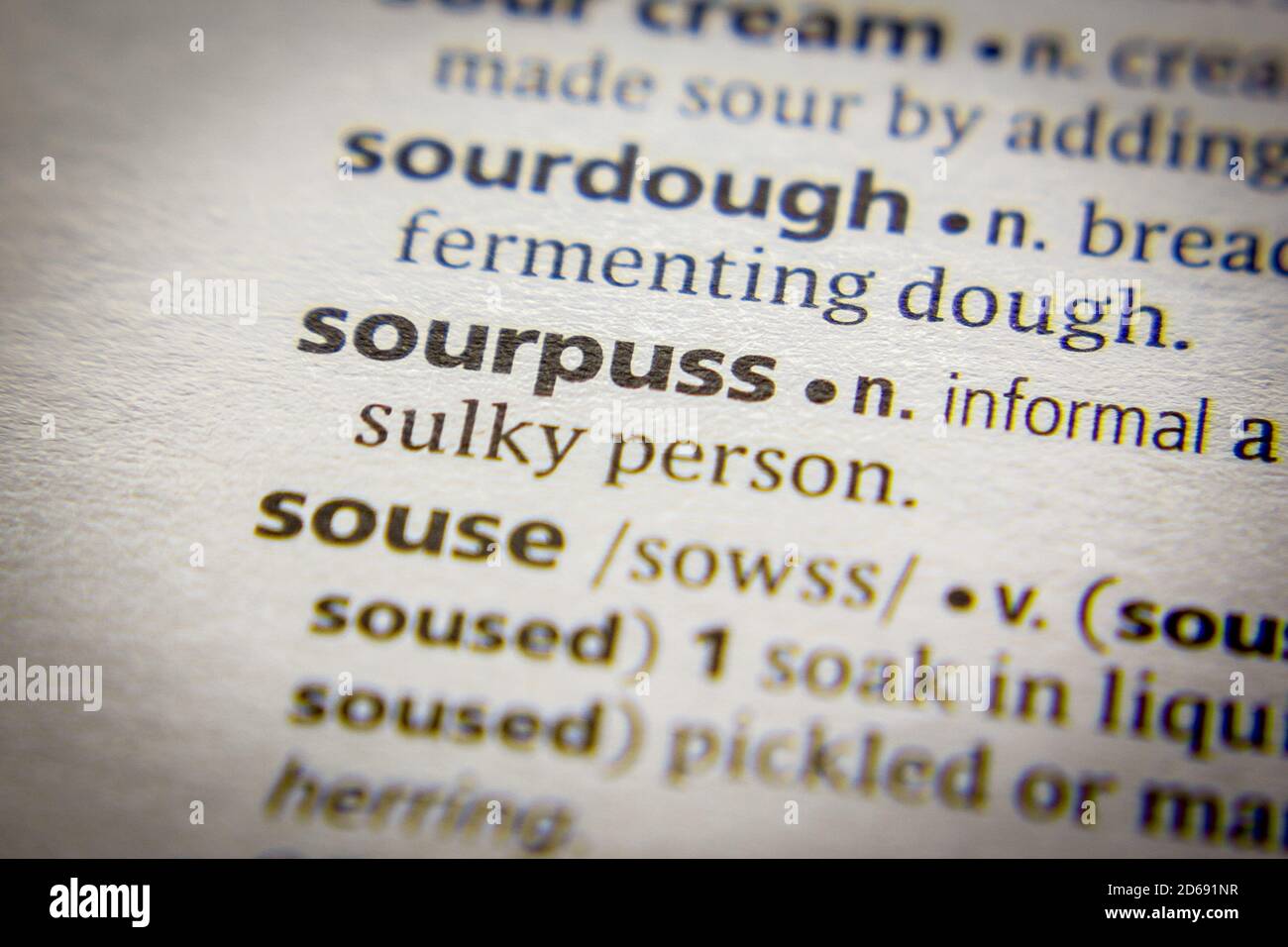 Word or phrase Sourpuss in a dictionary Stock Photo
