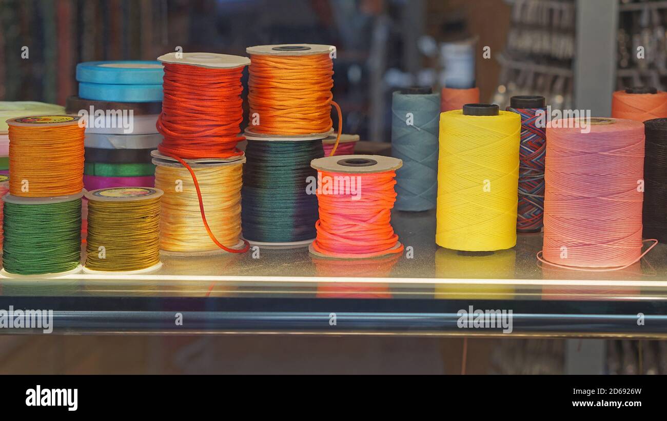 Colorful sewing threads and yarns at bobbins Stock Photo - Alamy