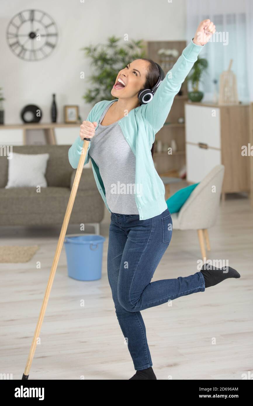 woman dancing and singling while mopping the floor Stock Photo Alamy