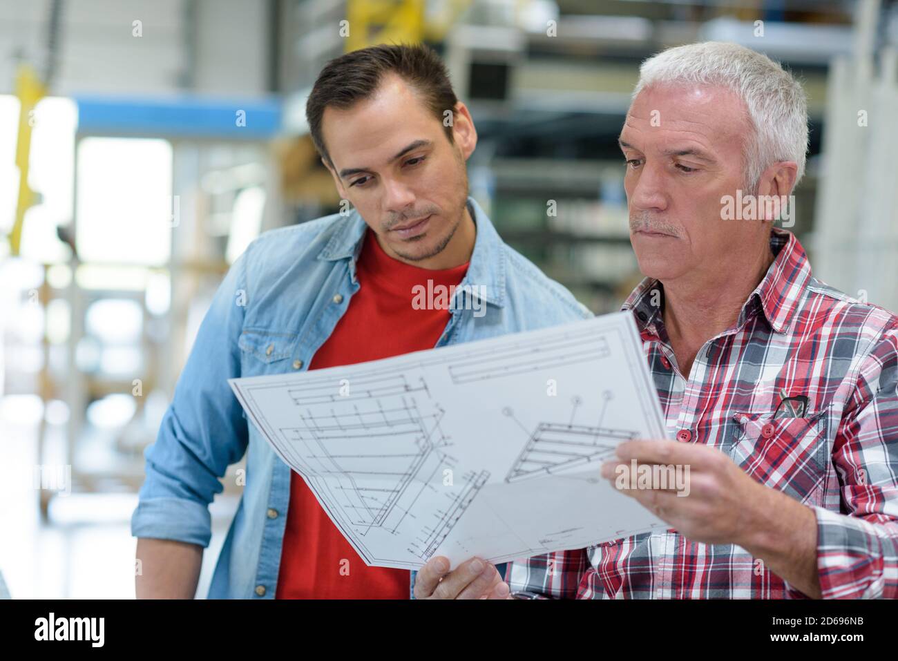 working engineers with factory plans Stock Photo - Alamy