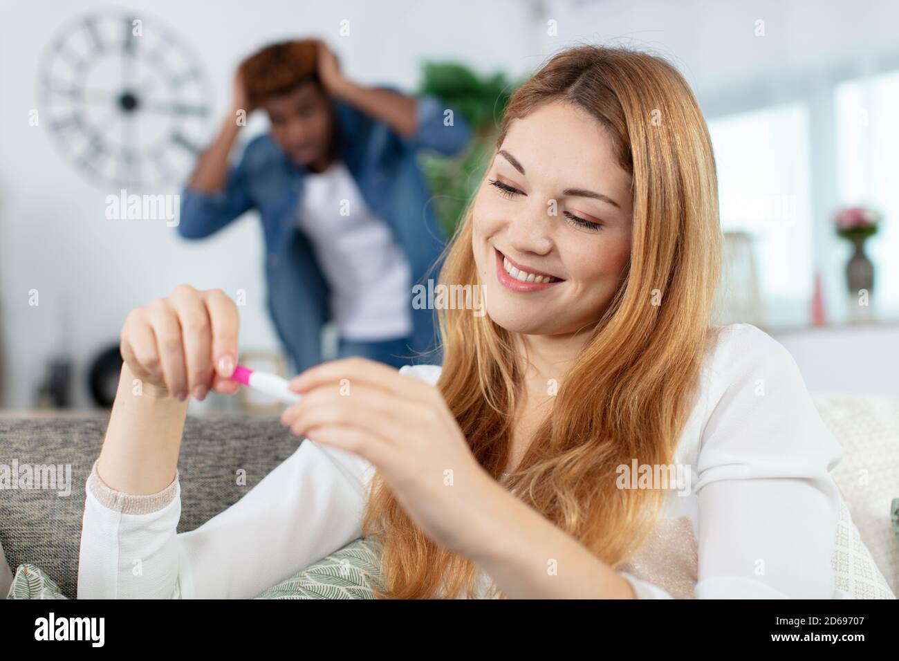 couple showing mixed emotions to a pregnancy test Stock Photo Alamy