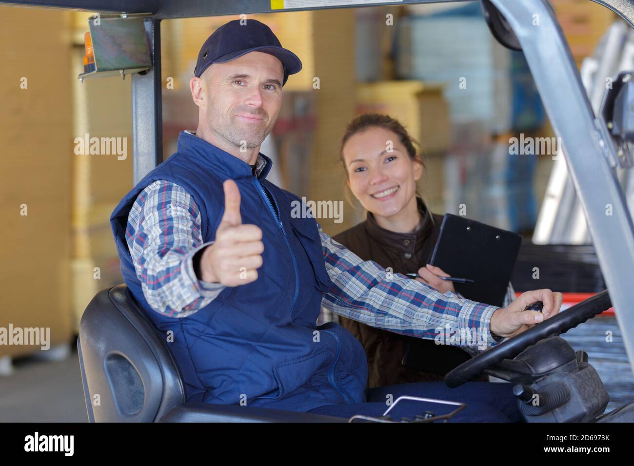 woman giving instructions to forklift driver Stock Photo Alamy
