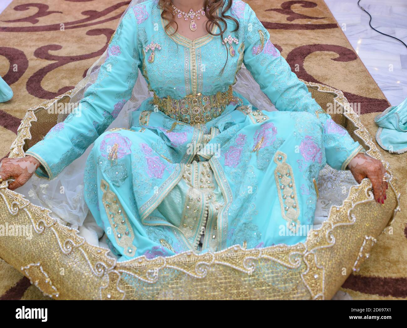 The traditional dress of the Moroccan bride. Beautiful bride wearing Moroccan caftan and precious jewelry Stock Photo