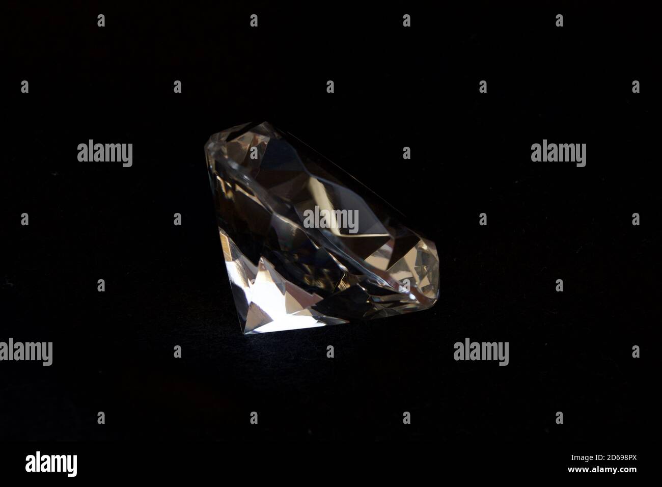 Diamond shaped transparent decorative crystal with black background. Stock Photo