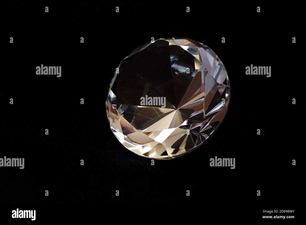 Diamond shaped transparent decorative crystal with black background. Stock Photo