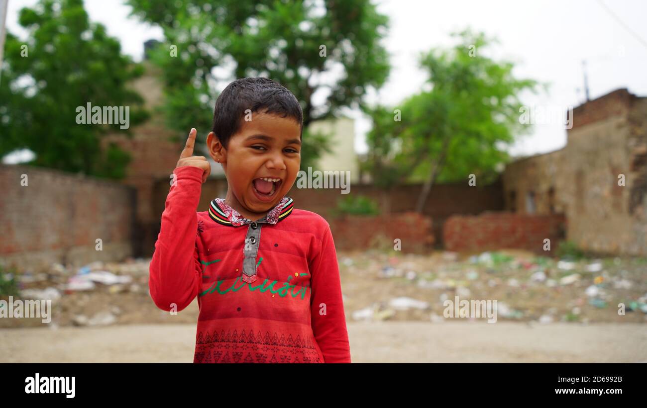 Sikar, Rajasthan, India - Aug 2020: happy smiling Indian little village girl standing. Smiling face portrait of a young child or young girl from rural Stock Photo