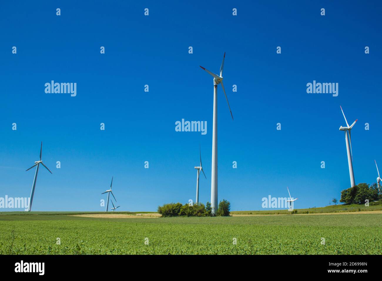Windmills on a German green field. Wind energy theme. Wind turbines