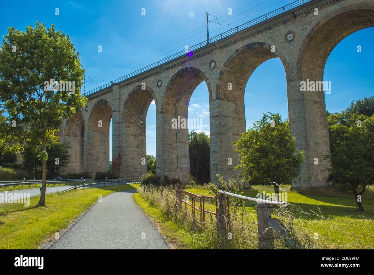 Train viaduct in Altenbeken, North Rhine Westphalia, Germany. Old stone railway surrounded by green park Stock Photo