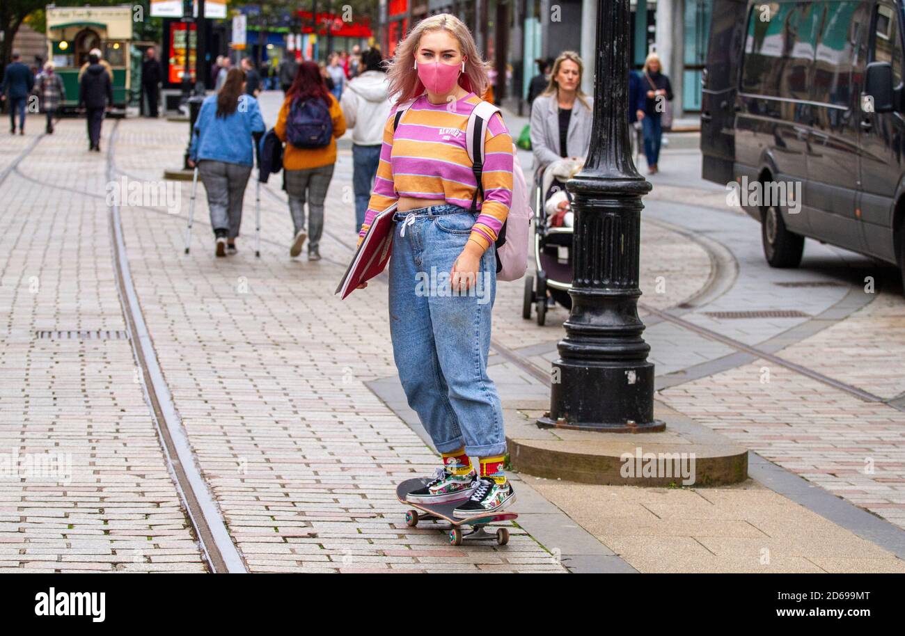 Dundee, Tayside, Scotland, UK. 15th Oct, 2020. UK Weather: Overcast and very chilly across North-East Scotland, maximum temperatures 10°C. A young blonde female skateboarder wearing a pink face mask skateboarding in Dundee city centre during the Covid-19 Lockdown. Credit: Dundee Photographics/Alamy Live News Stock Photo