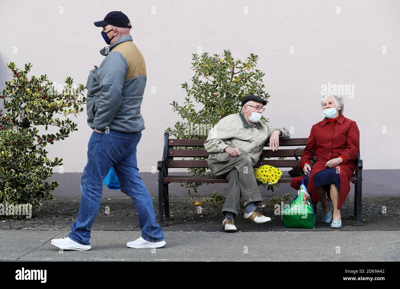 A man and a woman have a conversation on Main street, Co. Cavan, as counties Donegal, Cavan and Monaghan prepare to move to Level 4 of Ireland's Covid-19 plan from midnight tonight. Stock Photo