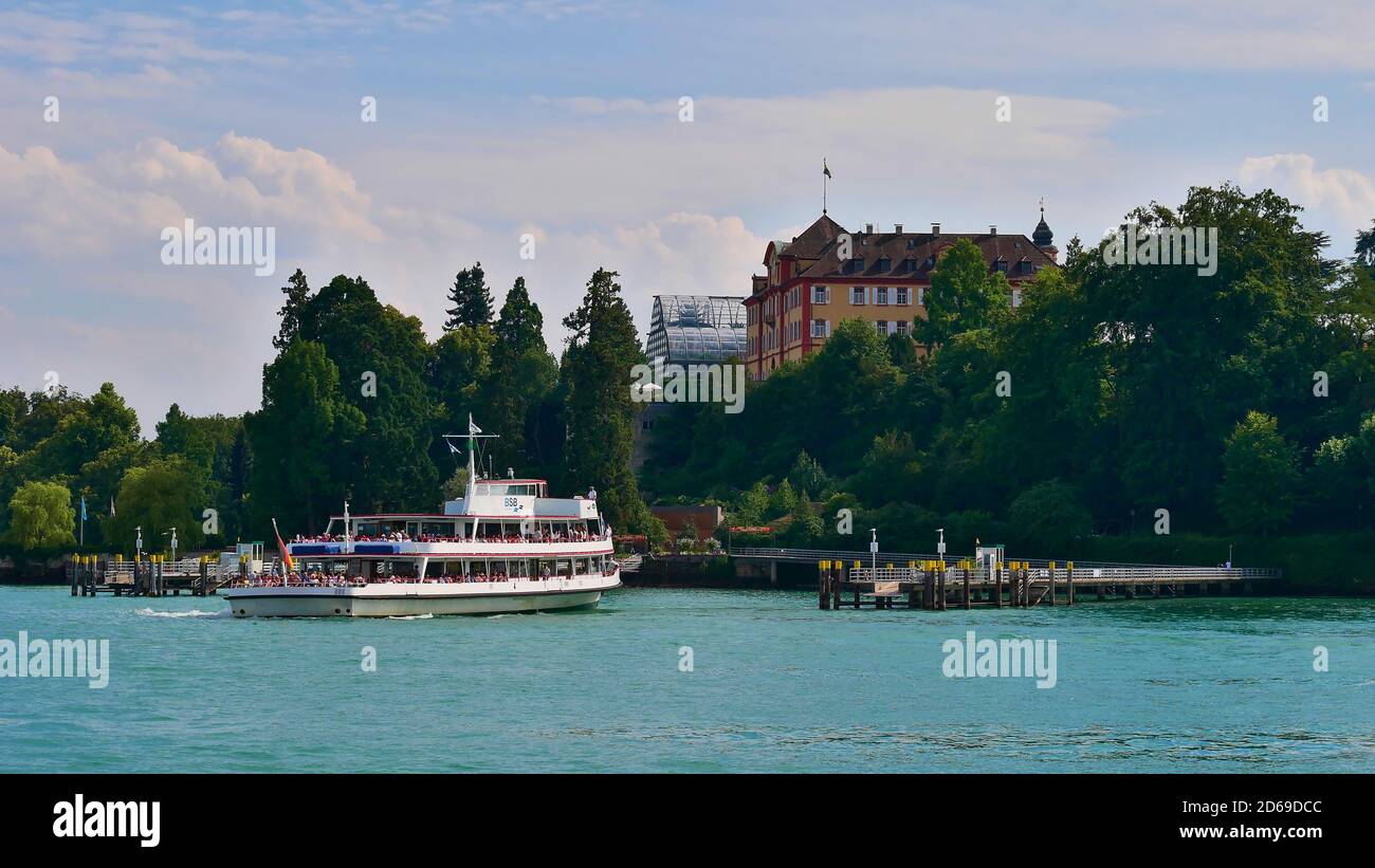 Mainau Island, Baden-Wuerttemberg, Germany - 07/14/2018: Passenger ferry ship arriving at landing stage of flower island Mainau, Lake Constance. Stock Photo