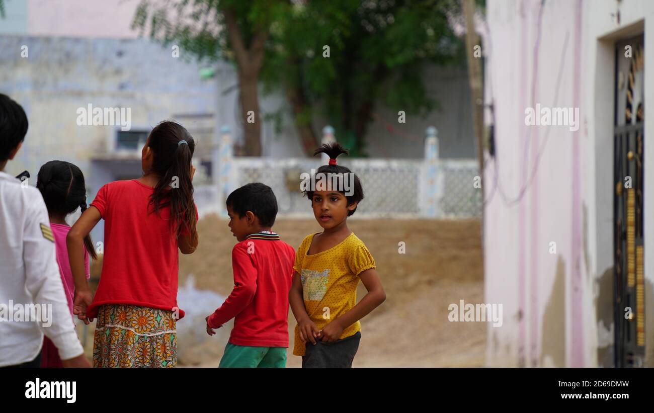 Sikar, Rajasthan, India - Aug 2020: Group of children from rural India smiling and having good time together away from the hustle of urban street Stock Photo