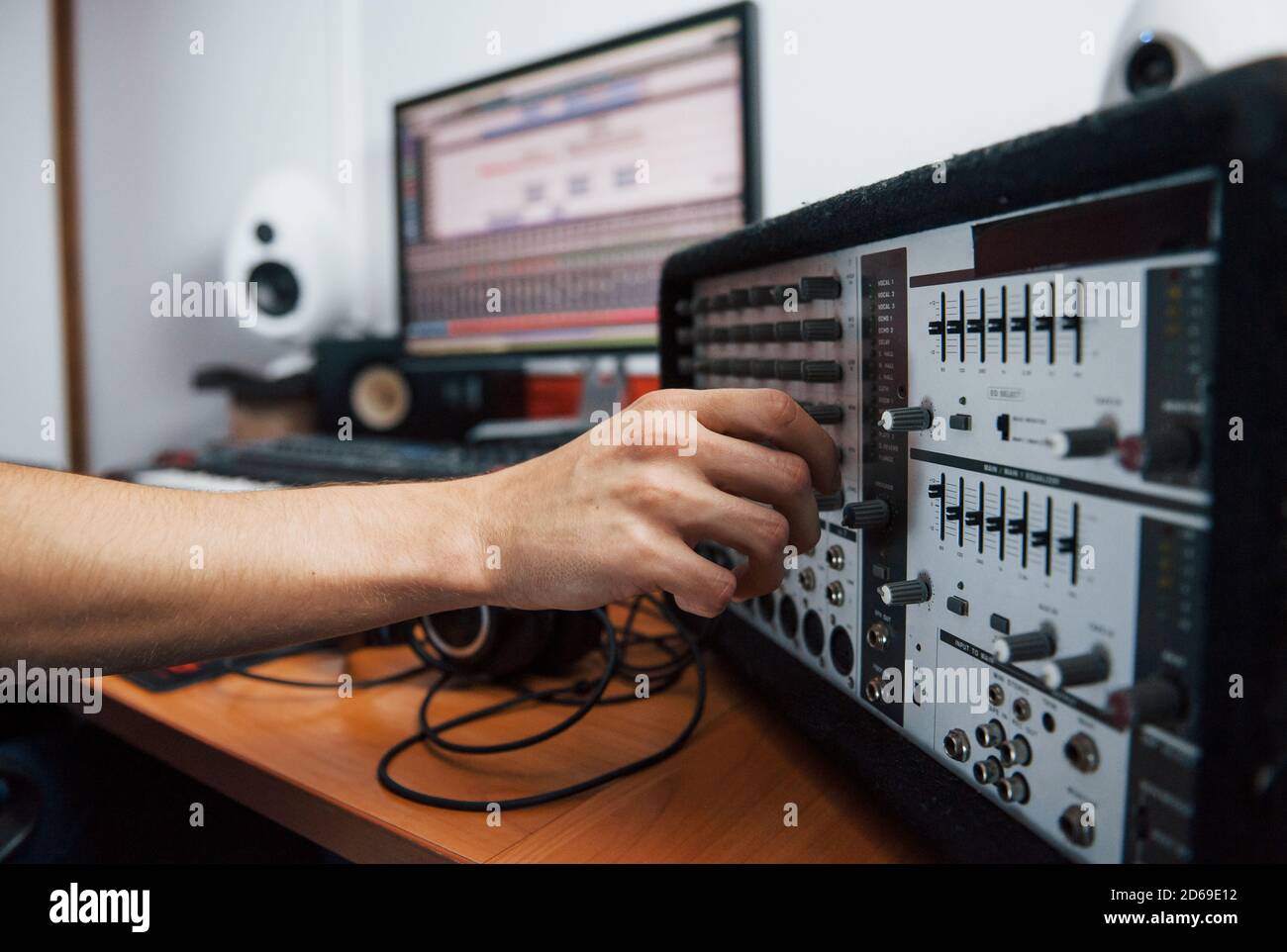 Using the mixer. Sound engineer working indoors in the studio Stock