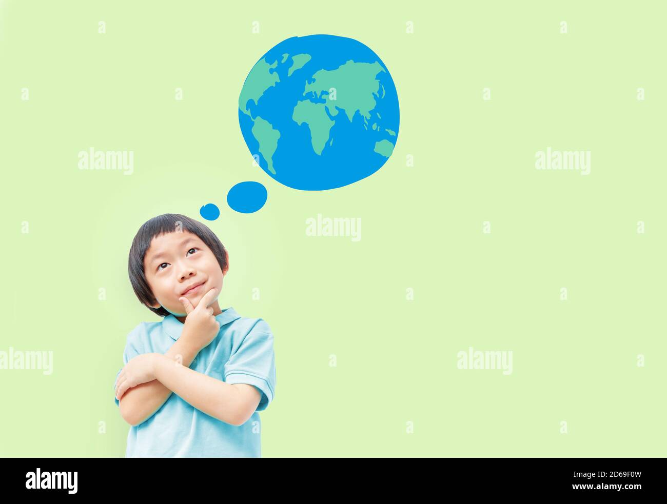 Think of the future of our children concept, Kid post arm on chin looking up to Earth on light green background Stock Photo