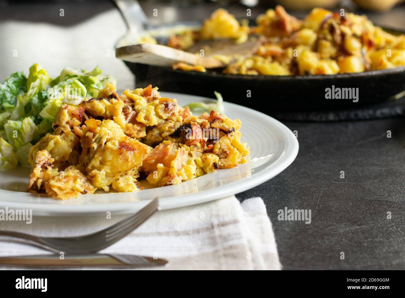fried potatoes with egg, ham and onions - farmers breakfast Stock Photo