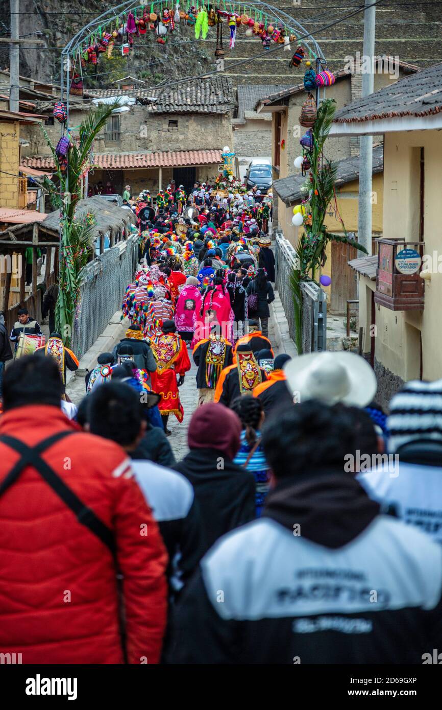 Religious procession, dancers dressed in colorful costumes carrying cross depicting the Senor de Choquekilca, Ollantaytambo, Cusco, Peru Stock Photo