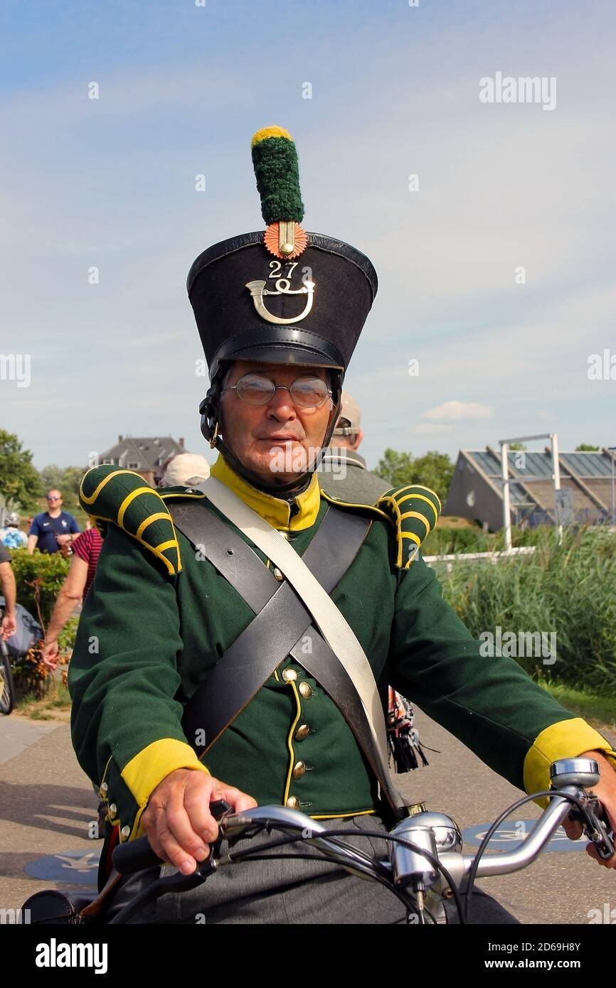 Man on bike dressed in traditional costume in Kinderdijk. Rotterdam. The Netherlands. July 2018. Stock Photo