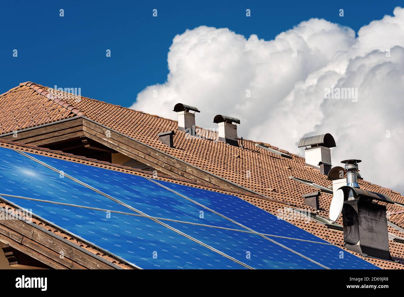 Close-up of a house roof with a solar panels on the top. Renewable ...