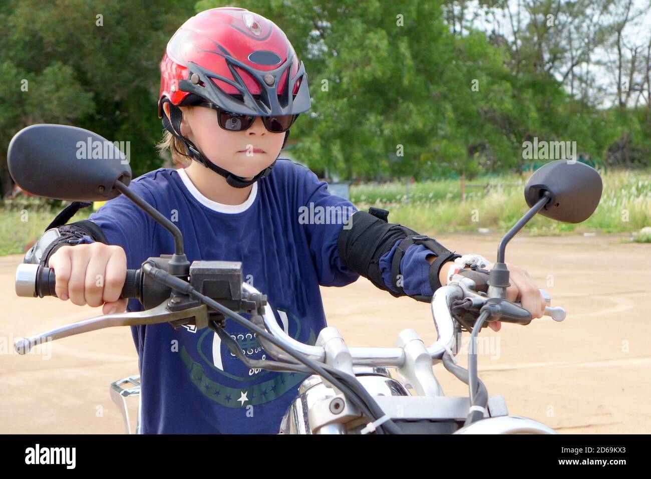 Young boy learning to ride an chopper motorcycle 3. Stock Photo