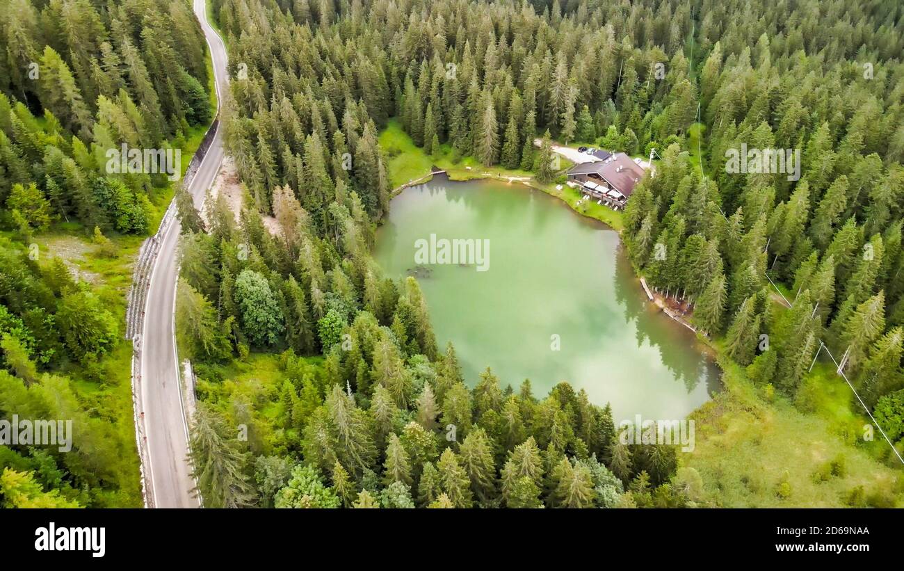 Beautiful Chalet in the middle of the forest, along a lake border. Stock Photo