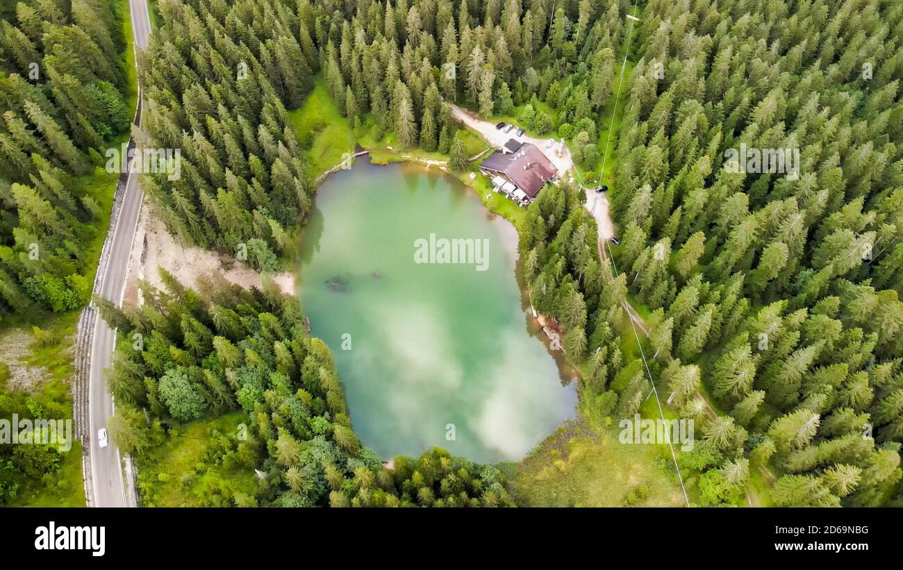 Beautiful Chalet in the middle of the forest, along a lake border. Stock Photo