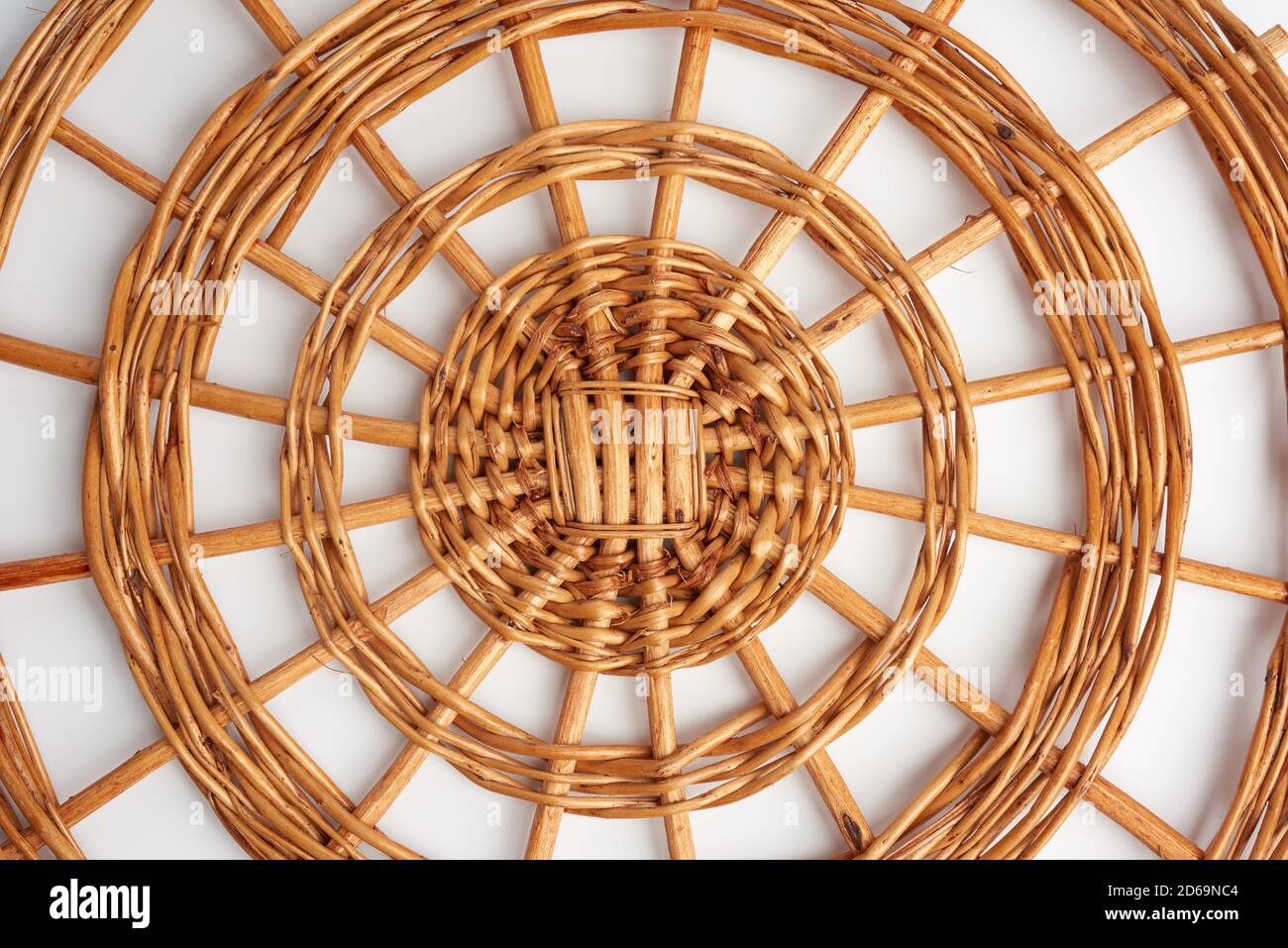round wicker stand for pots on a white background, top view Stock Photo