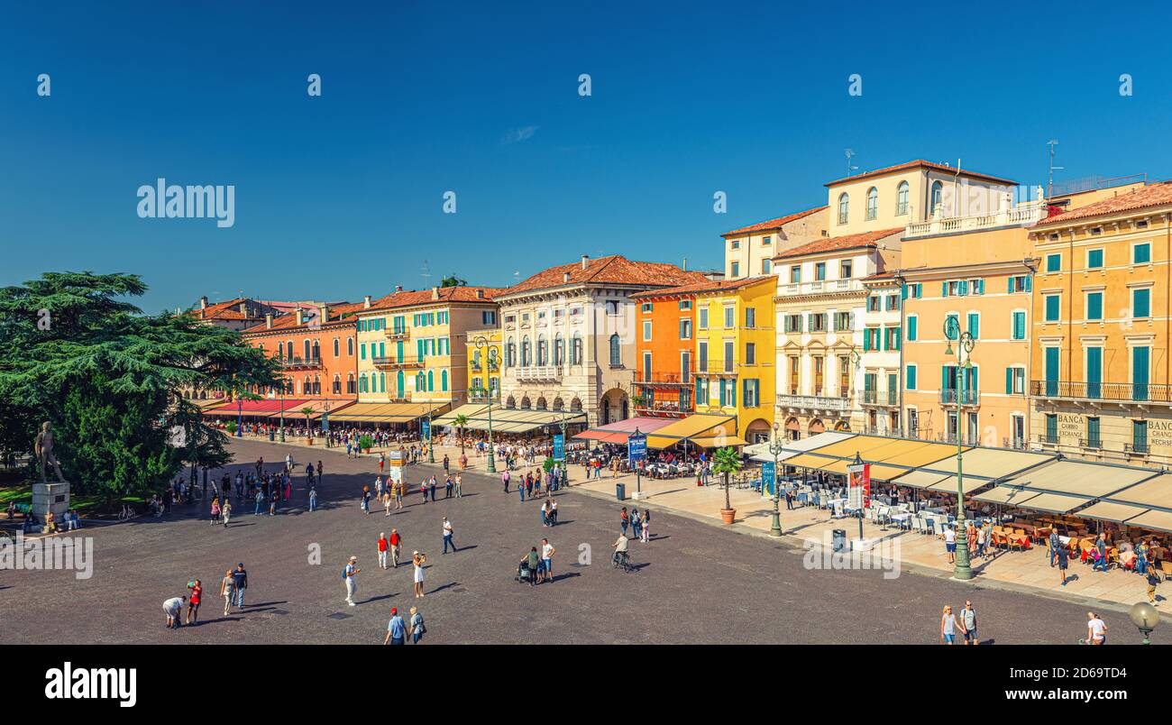 Verona, Italy, September 12, 2019: panorama of Piazza Bra square aerial view in historical city centre with row of old colorful multicolored buildings cafes and restaurants and walking tourists Stock Photo