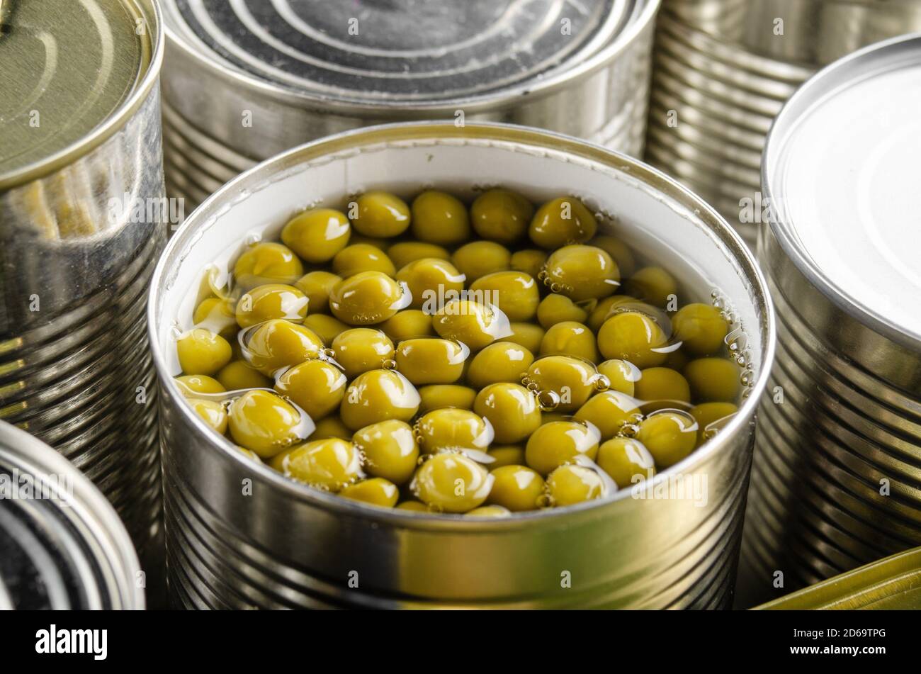 Canned green peas in just opened tin can. Nonperishable food Stock