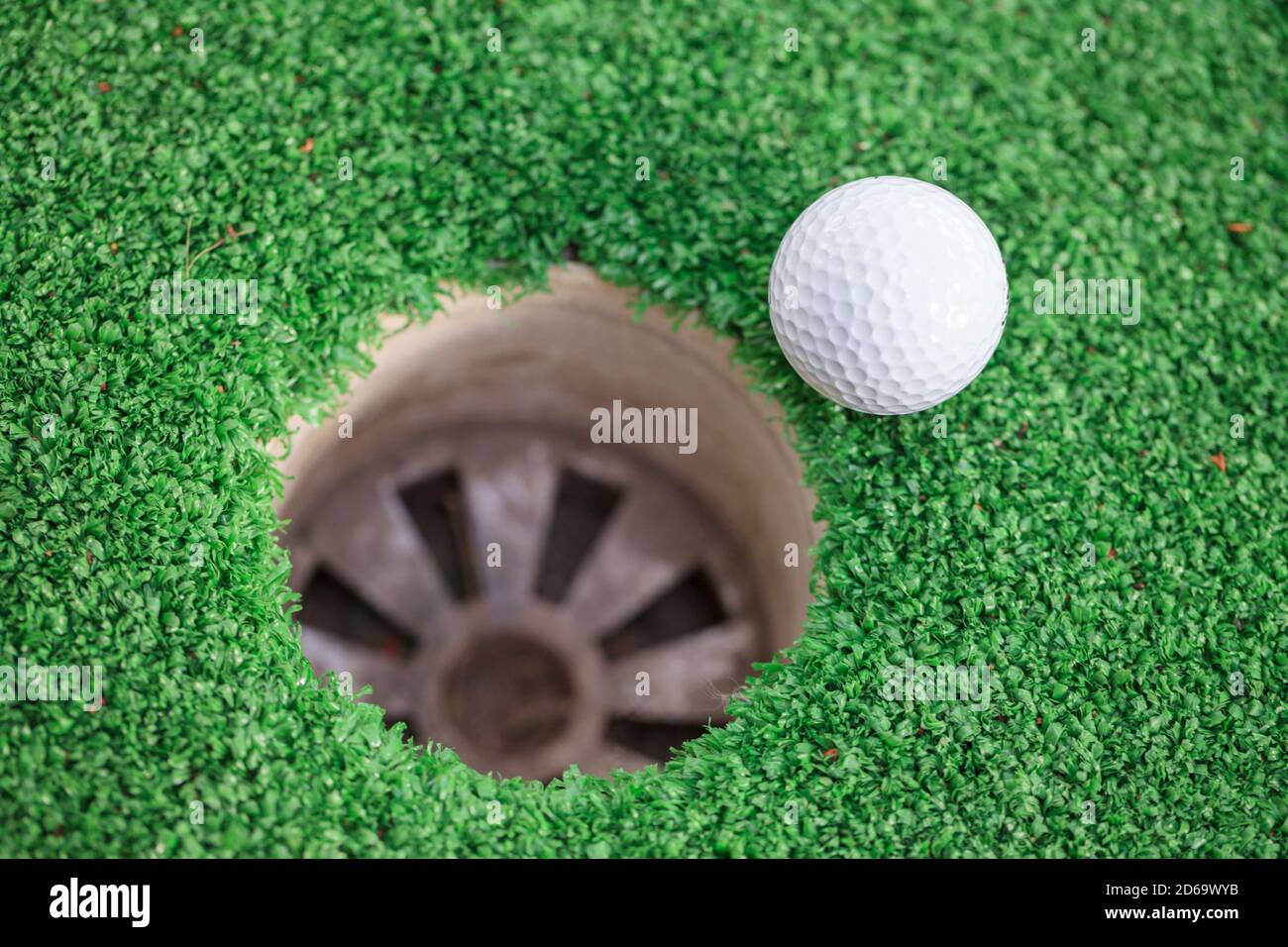 golf-ball-on-lip-of-cup-stock-photo-alamy