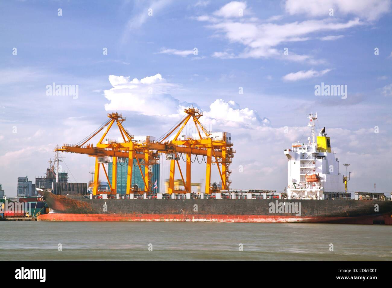 Container Cargo freight Industrail ship with working crane bridge unloading and loading goods in Bangkok shipyard Terminal for Logistic Import Export Stock Photo