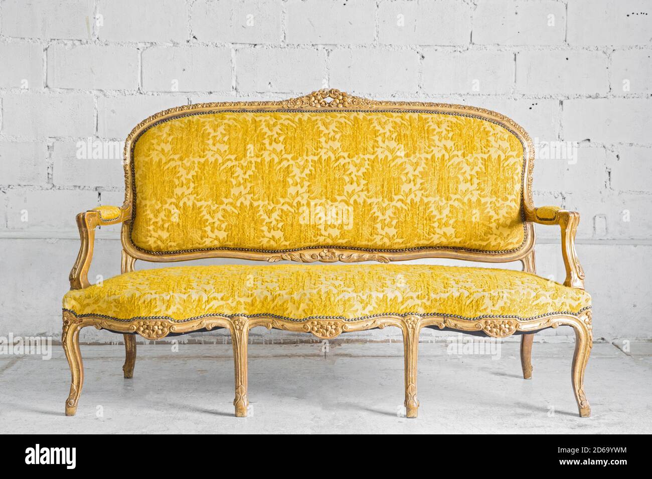 Vintage luxury Yellow sofa Armchair in white brick wall room Stock