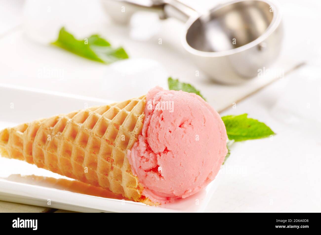 Raspberry ice cream cone over white background Stock Photo Alamy