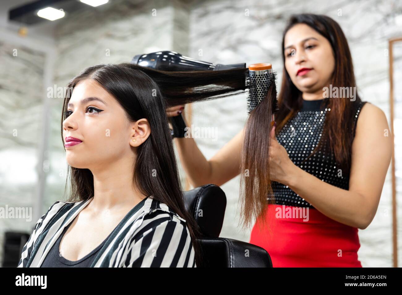 A hair dresser provides hair styling services to a pretty young Indian woman, beautiful woman gets her hair done at a salon, selective focus Stock Photo - Alamy A hair dresser provides hair styling services to a pretty young Indian woman, beautiful woman gets her hair done at a salon, selective focus Stock Photo - Alamy