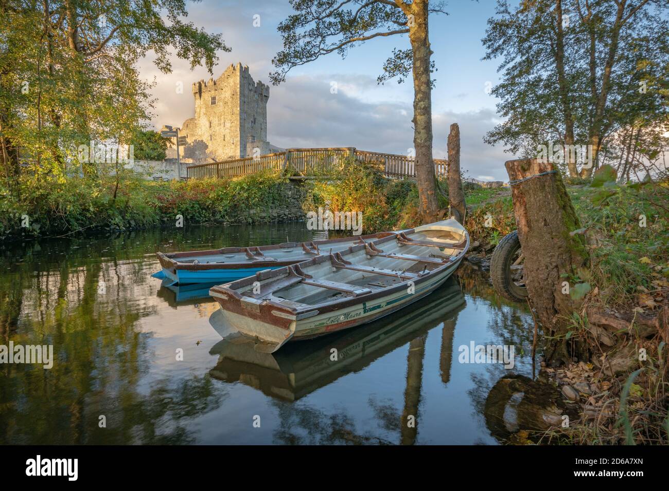 Moored row boats and a view of Ross Castle on shore of Lough Leane in Killarney National Park in Ireland Stock Photo